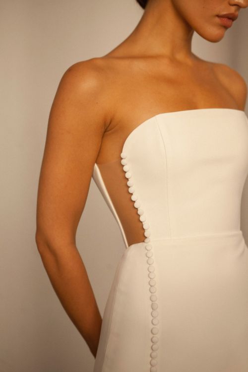 minimalist wedding dress, side cut out wedding dress, strapless wedding dress, corset wedding dress, sheath wedding dress, crepe wedding dress, modern wedding dress, slit wedding dress, fitted wedding dress, button front wedding dress, straight neckline wedding dress, bridal gown, simple wedding dress